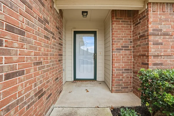 a view of a brick house with a large window