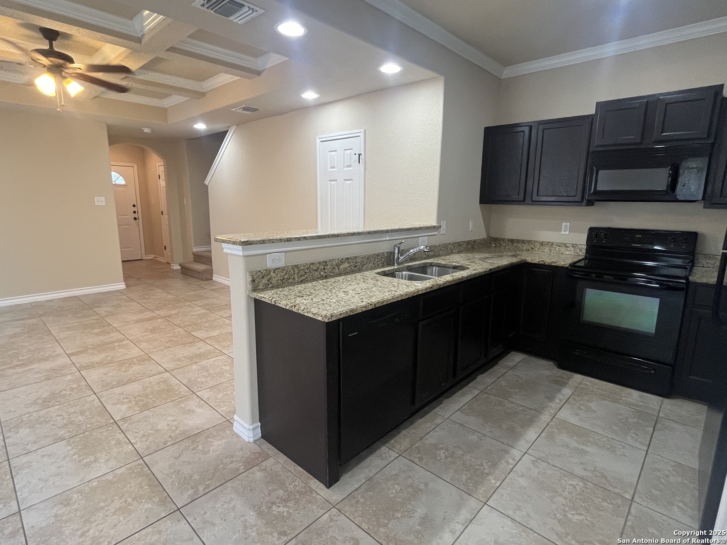 16824 Dancing Ava, Unit 1 Selma, TX 78154 - Photo 11 of 26 a kitchen with stainless steel appliances granite countertop a stove a sink and a microwave