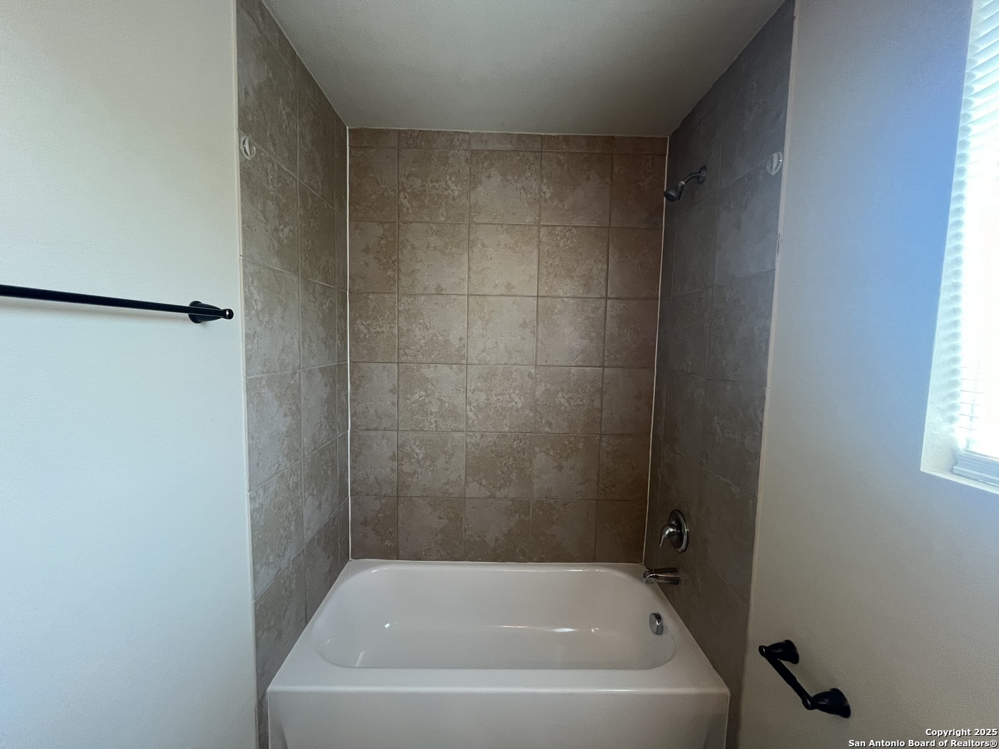 16824 Dancing Ava, Unit 1 Selma, TX 78154 - Photo 25 of 26 a white bath tub sitting next to a window