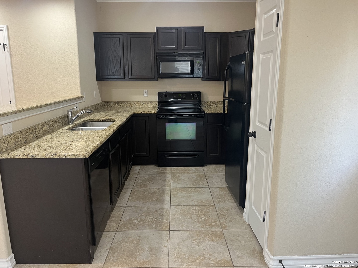 16824 Dancing Ava, Unit 1 Selma, TX 78154 - Photo 9 of 26 a kitchen with a refrigerator and a stove top oven