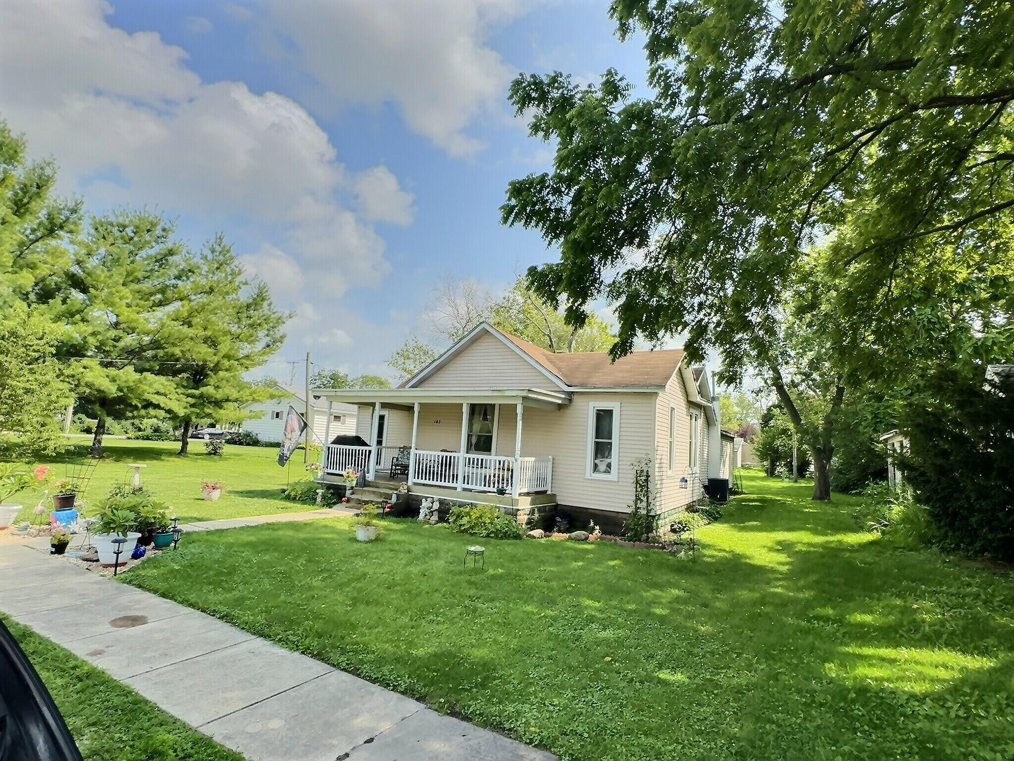 a front view of house with yard and green space