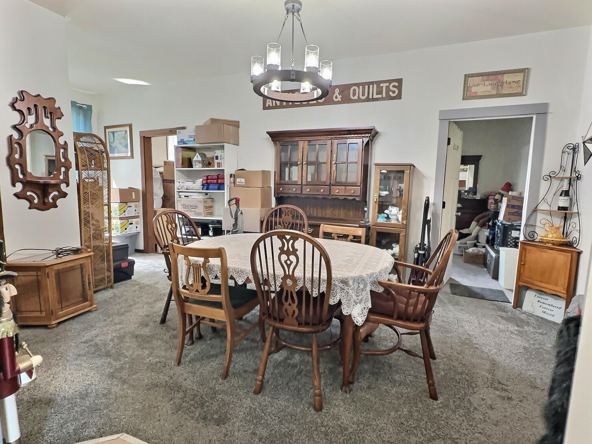 103 West Goss Street Kentland, IN 47951 - Photo 12 of 26 a dining room with furniture a chandelier and window