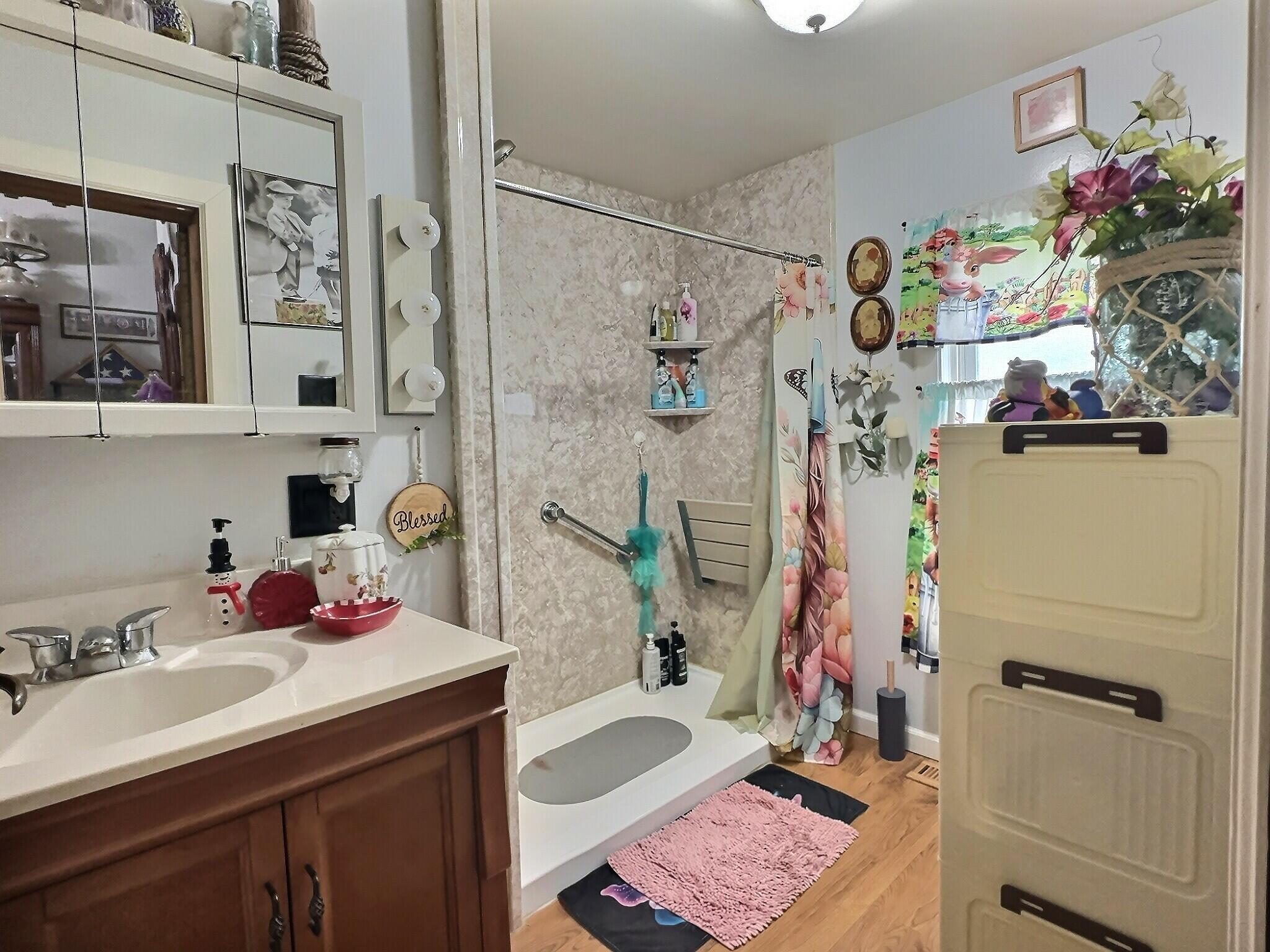 103 West Goss Street Kentland, IN 47951 - Photo 14 of 26 a bathroom with a sink mirror and vanity