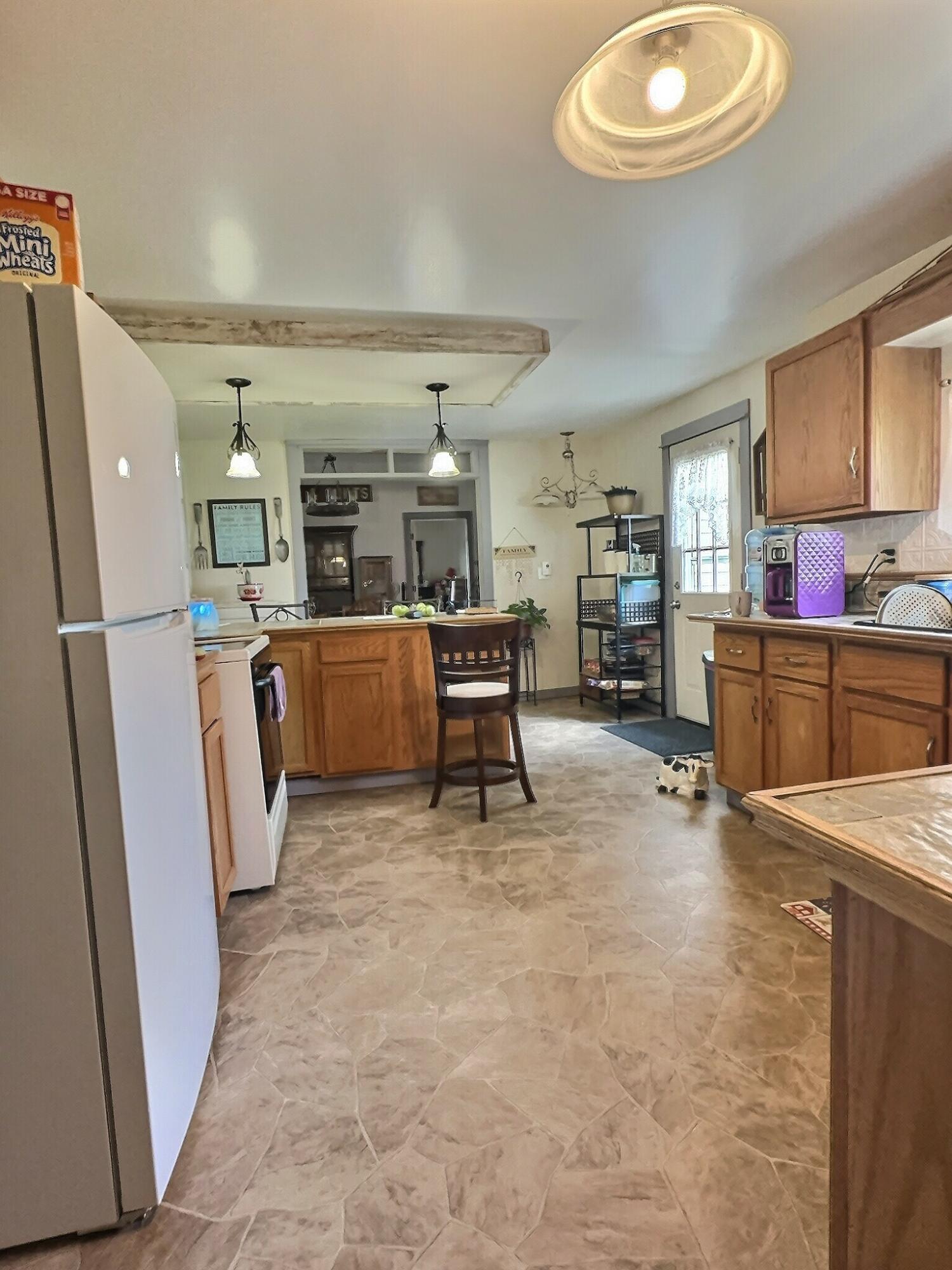 103 West Goss Street Kentland, IN 47951 - Photo 20 of 26 a living room with stainless steel appliances furniture and a kitchen view