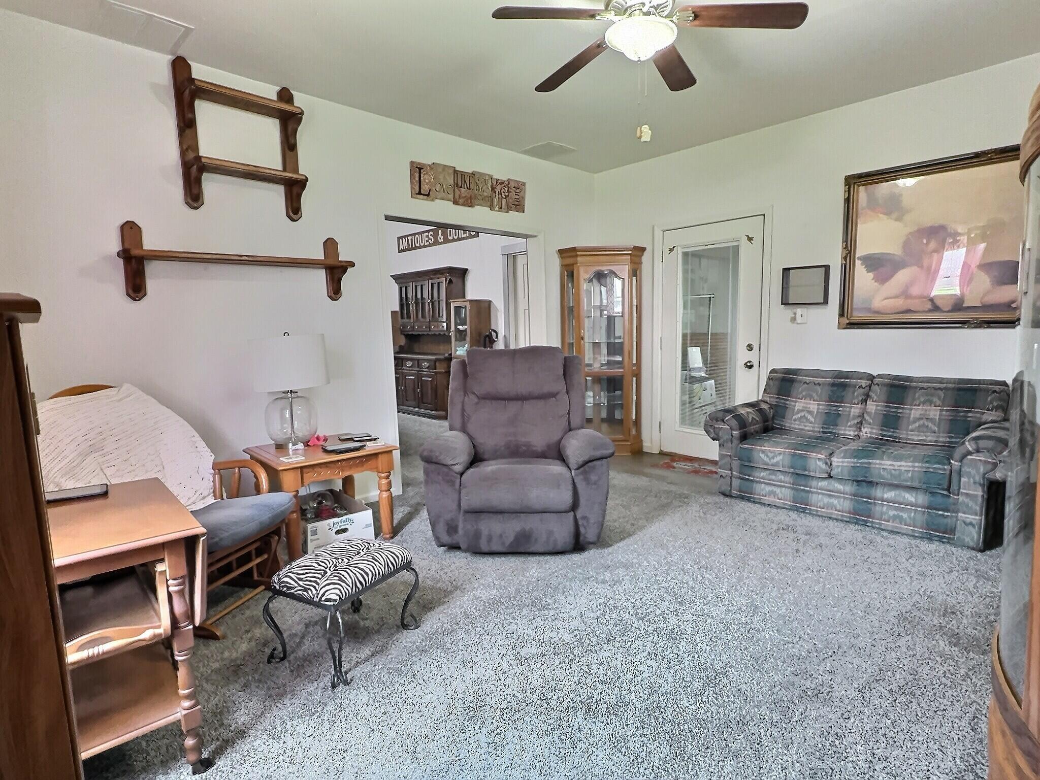 103 West Goss Street Kentland, IN 47951 - Photo 2 of 26 a living room with furniture and a fireplace