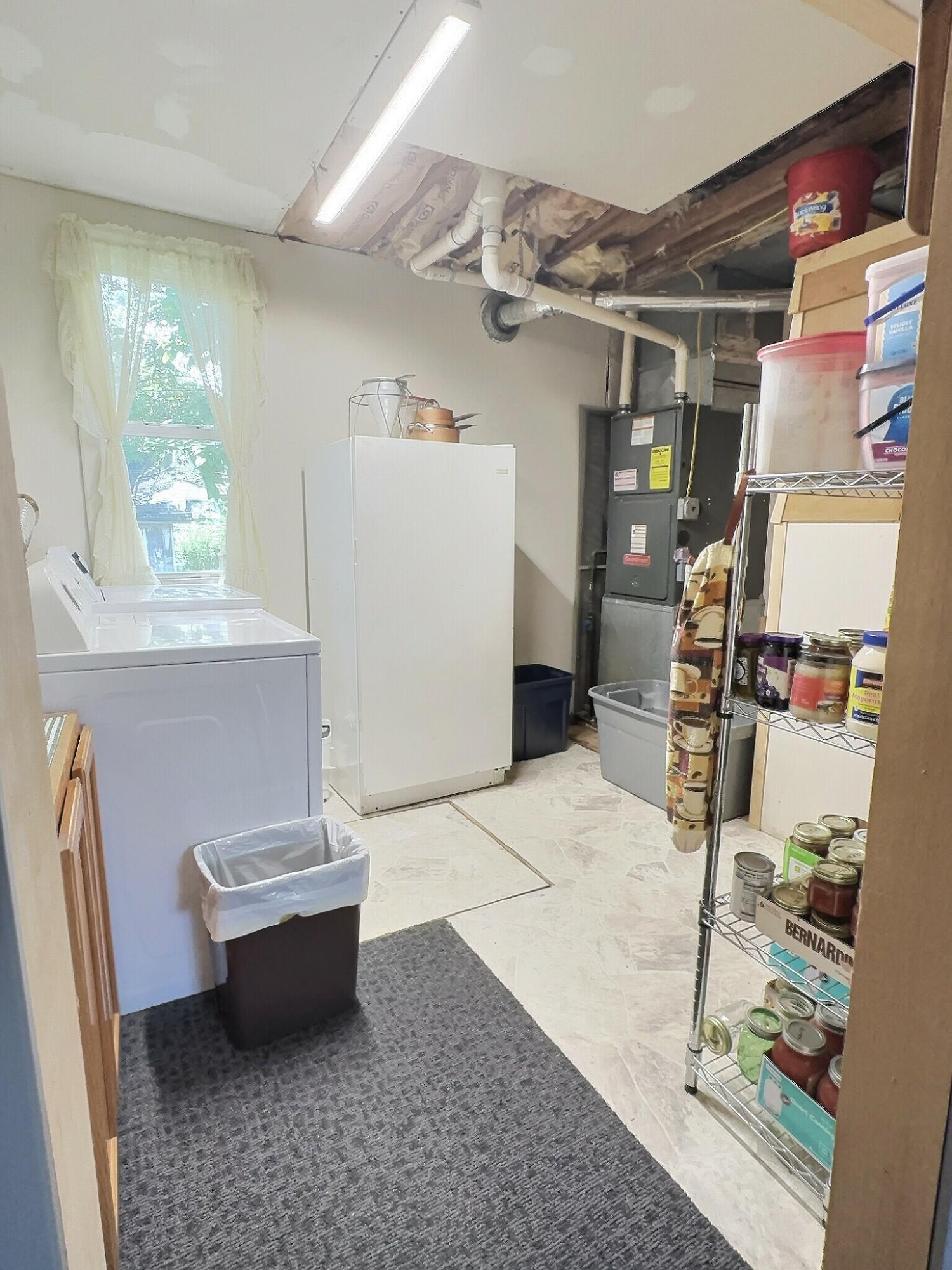 103 West Goss Street Kentland, IN 47951 - Photo 21 of 26 a bath room with a washer and dryer