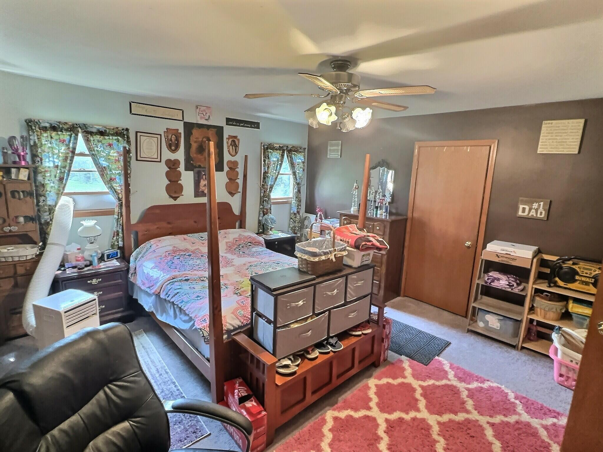 103 West Goss Street Kentland, IN 47951 - Photo 4 of 26 a bedroom with a bed a couch and dresser
