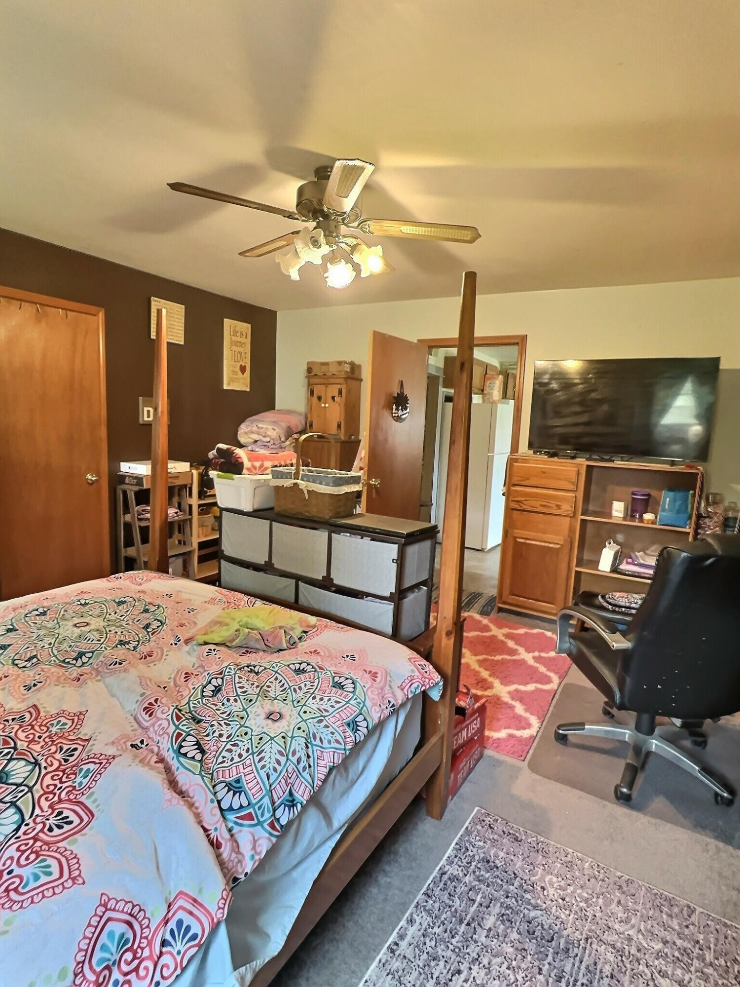 103 West Goss Street Kentland, IN 47951 - Photo 5 of 26 a bedroom with a bed and wooden floor