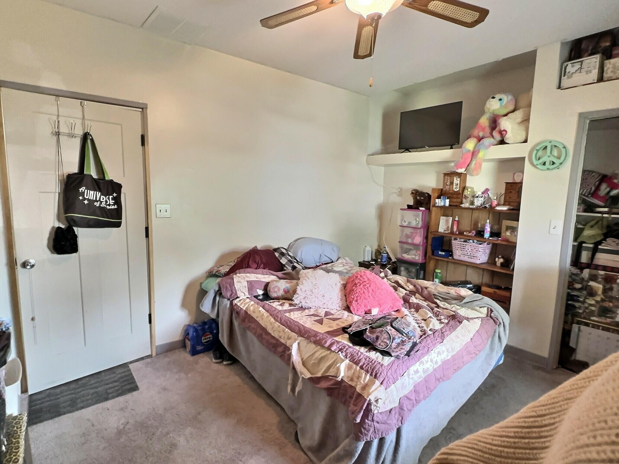 103 West Goss Street Kentland, IN 47951 - Photo 8 of 26 a bed room with a bed and a flat screen tv