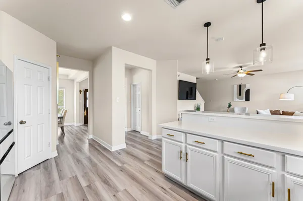 a living room with furniture a flat screen tv and a window
