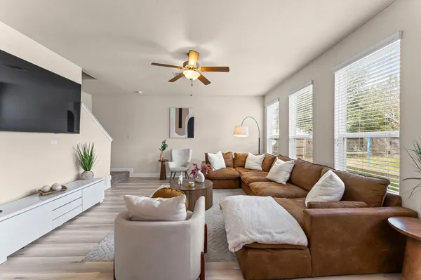 a living room with furniture and a view of kitchen