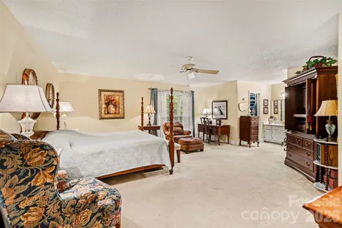 a bedroom with bed and a chandelier