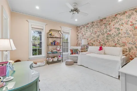 a bedroom with furniture and a large window
