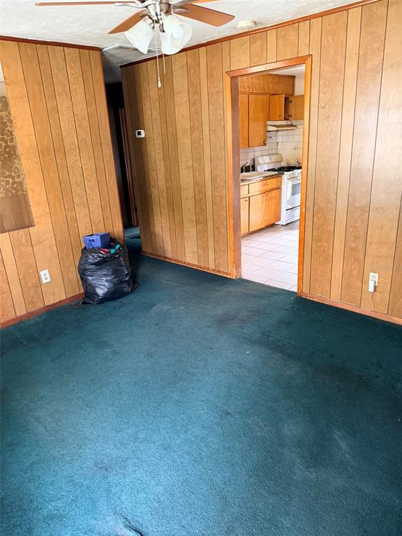 2114 Southwest 7th Street Ocala, FL 34471 - Photo 6 of 10 a view of an empty room with a fireplace and a window