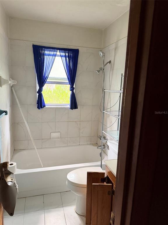 2114 Southwest 7th Street Ocala, FL 34471 - Photo 7 of 10 a bathroom with a bathtub toilet and a shower