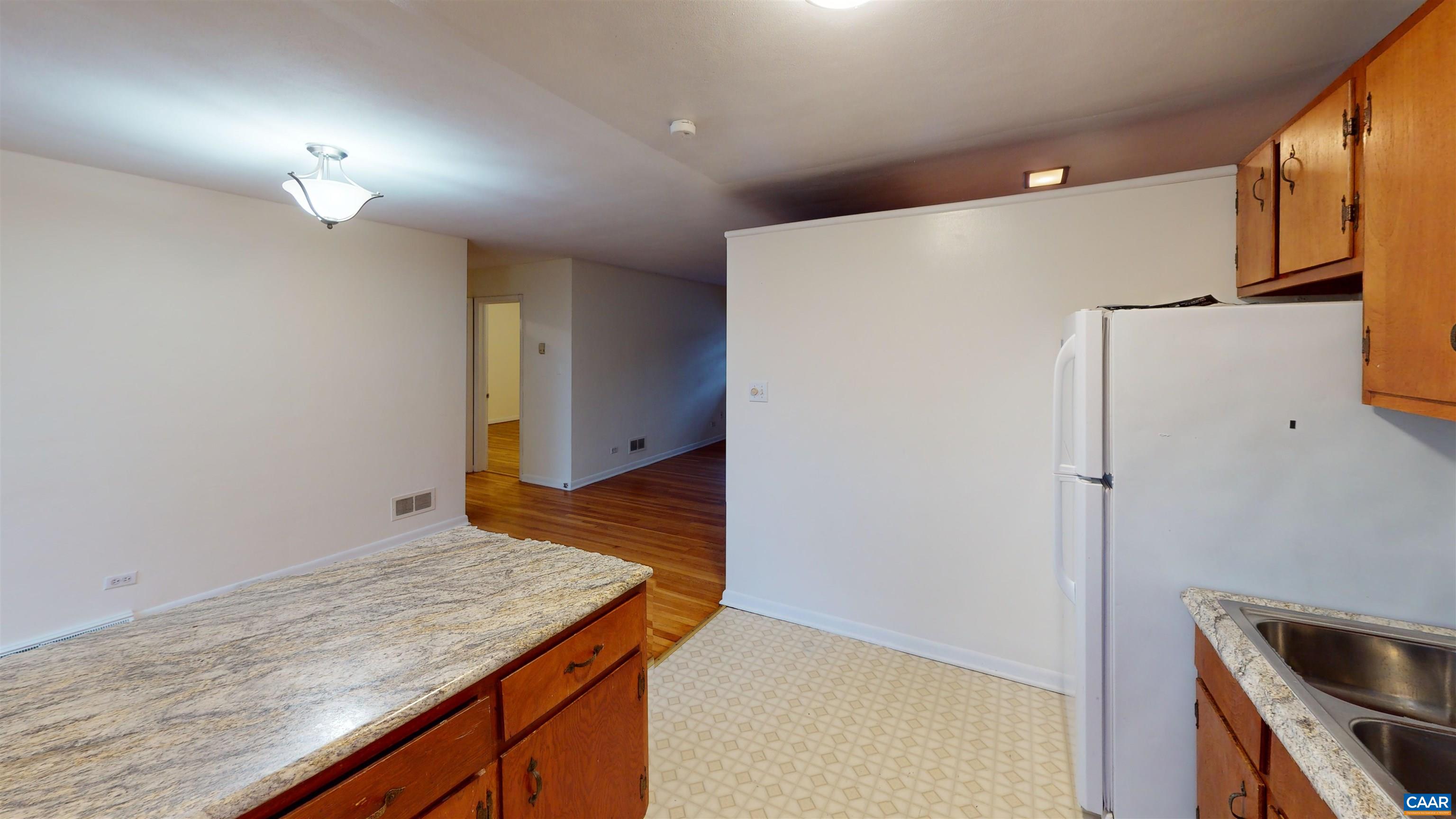 130 Apple Tree Road, Unit A Charlottesville, VA 22903 - Photo 13 of 16 a kitchen with a refrigerator and countertop