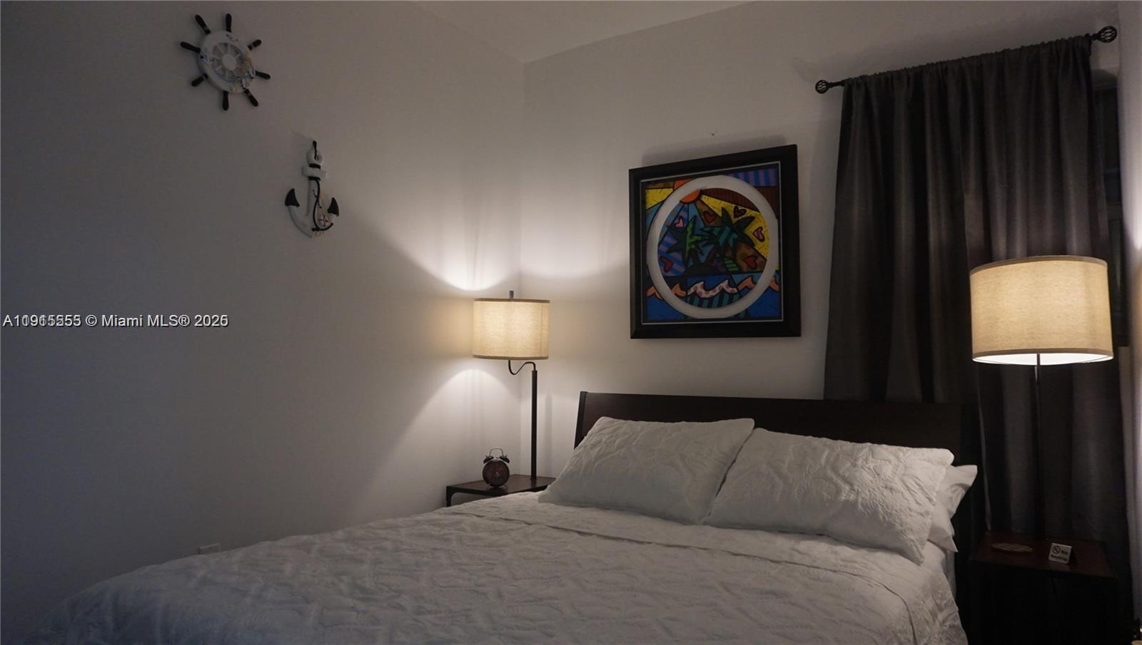 810 7th Street, Unit 107 Miami Beach, FL 33139 - Photo 11 of 14 a bedroom with a lamp and a lamp on dresser