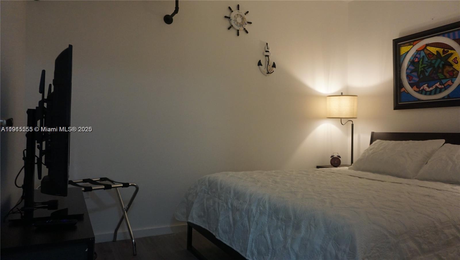 810 7th Street, Unit 107 Miami Beach, FL 33139 - Photo 12 of 14 a bedroom with a bed and chair