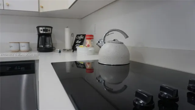 a bedroom with a lamp and a lamp on dresser