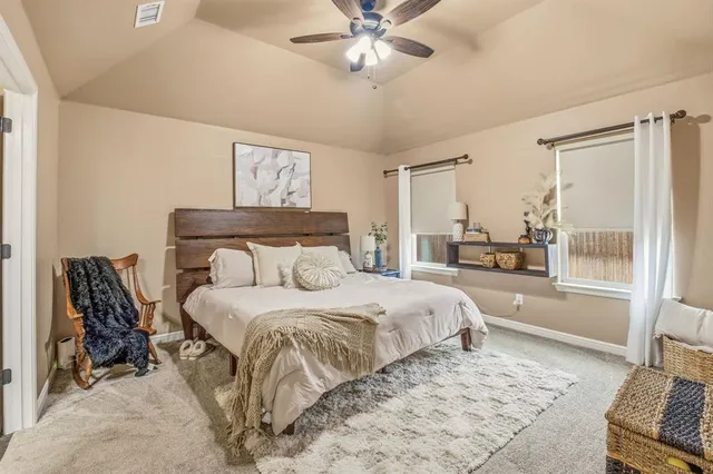 a bedroom with a large bed and a window