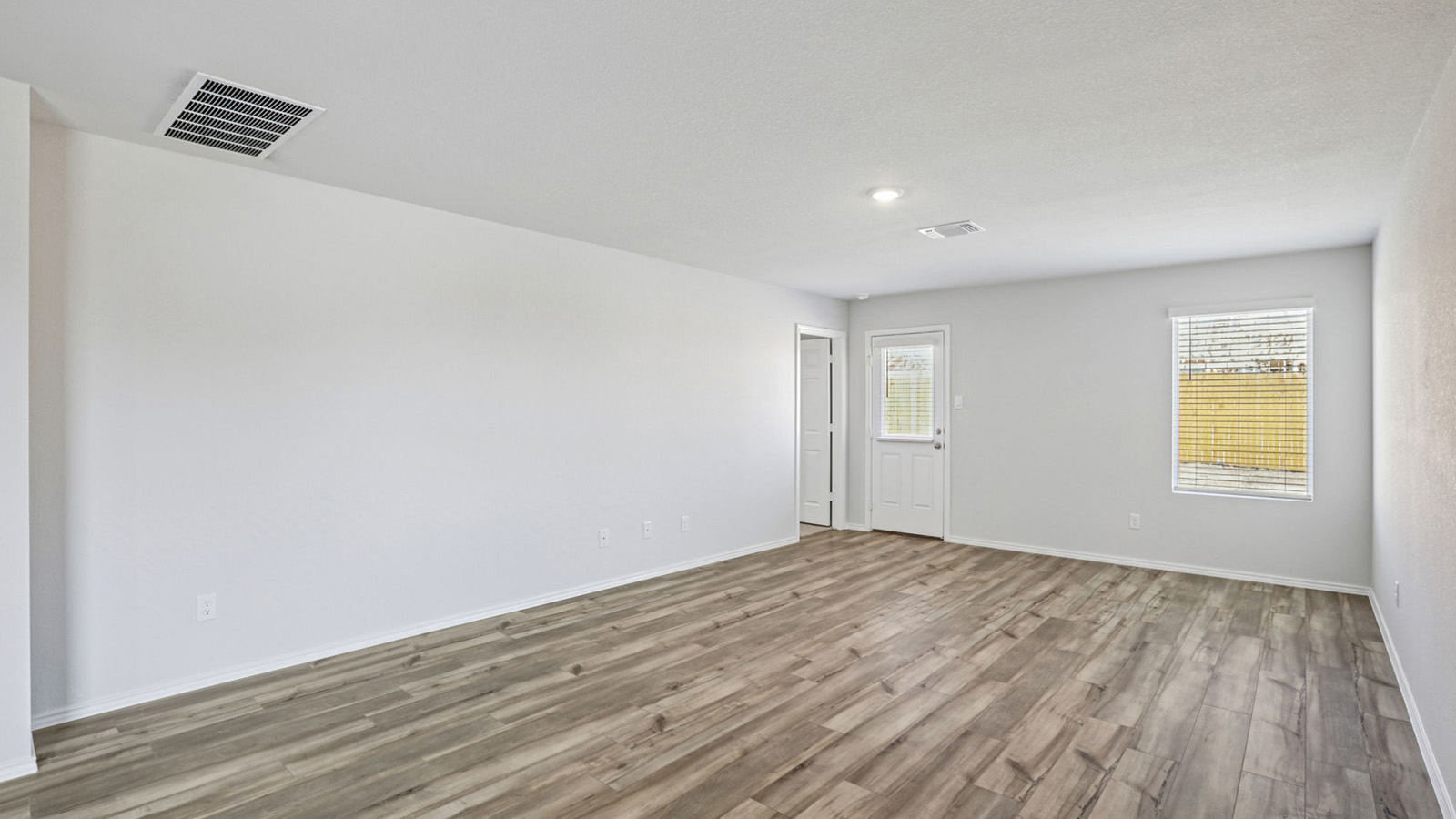 156 Wyatt Way Jarrell, TX 76537 - Photo 12 of 30 Spacious room featuring wood-finish flooring, light-toned walls, and recessed lighting