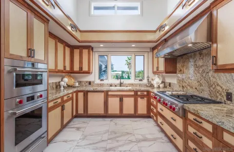 a large kitchen with stainless steel appliances granite countertop a stove and a sink