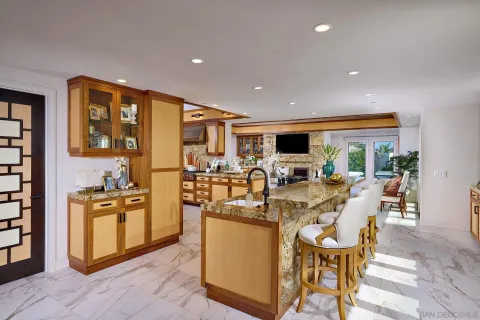 a very nice looking kitchen with granite countertop a stove and cabinets