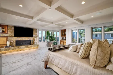 a spacious bedroom with a bed and large windows