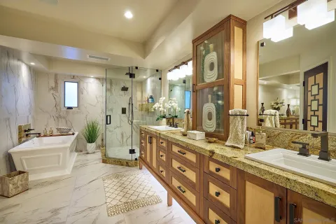 a spacious bathroom with a granite countertop sink mirror and a shower