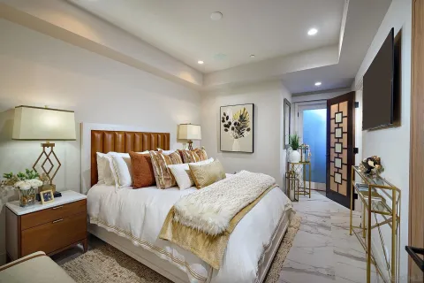 a bedroom with a large bed and a couch
