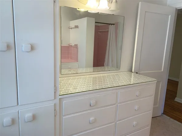 a bathroom with a granite countertop sink and mirror