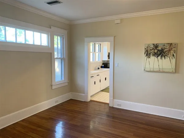 a view of a room with wooden floor and windows