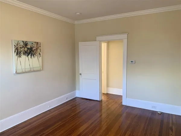 a view of a room with wooden floor and a window