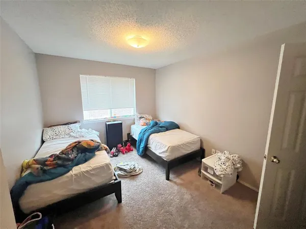 a bedroom with bed and a window