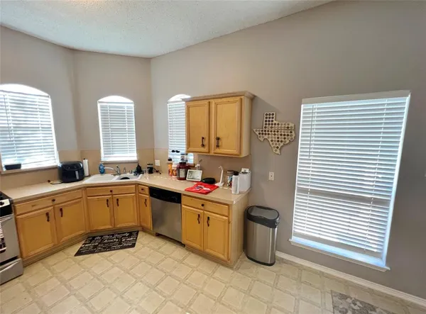 a kitchen with a sink stove and cabinets