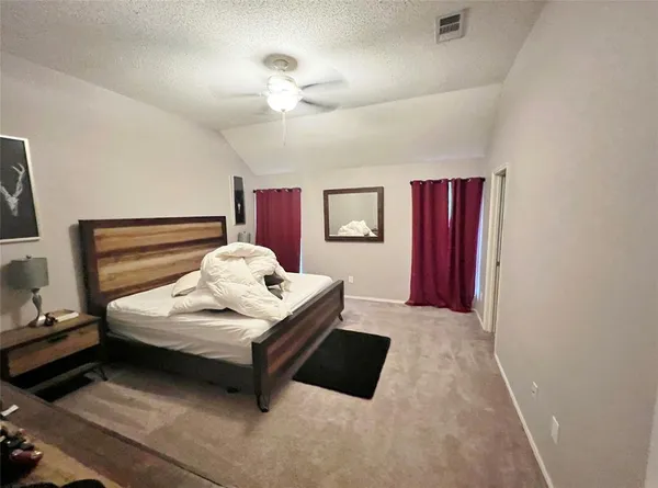 a bedroom with a bed and window