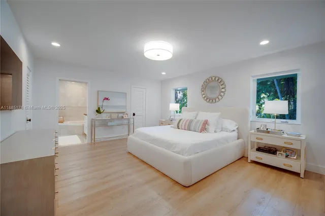 a bedroom with a bed and a view of kitchen