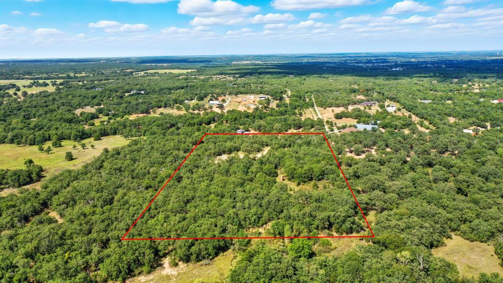 785 Jordan Road Poolville, TX 76487 - Photo 4 of 17 Aerial view of property's location with a heavily wooded area and property boundaries highlighted