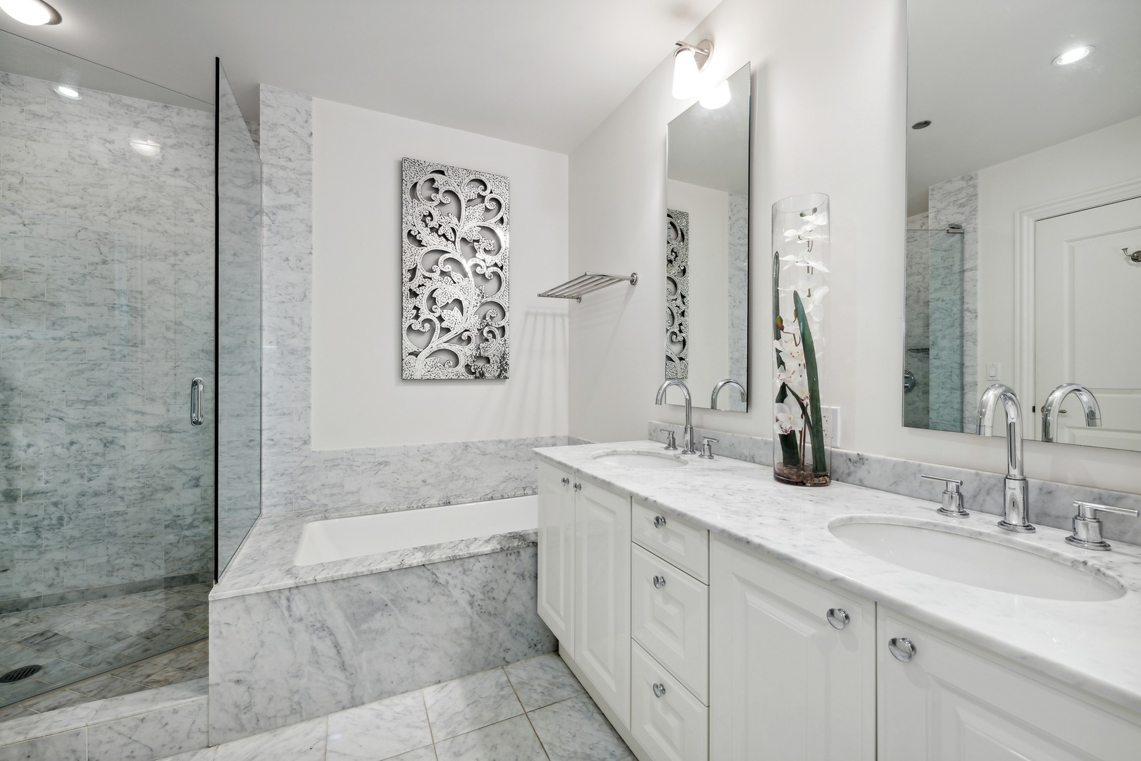 10 East Delaware Place, Unit 12E Chicago, IL 60611 - Photo 13 of 25 a bathroom with a granite countertop double vanity sink a mirror and a shower