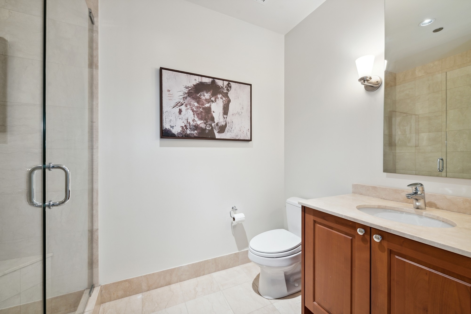10 East Delaware Place, Unit 12E Chicago, IL 60611 - Photo 16 of 25 a bathroom with a toilet sink vanity and shower