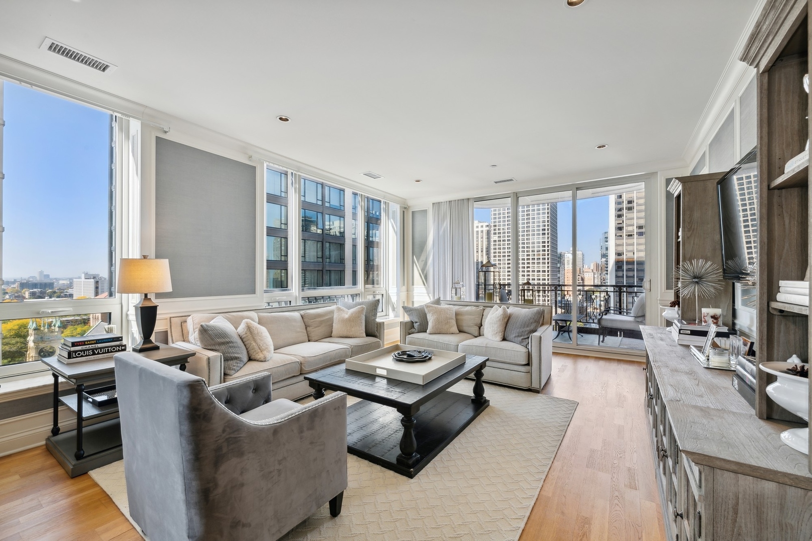 10 East Delaware Place, Unit 12E Chicago, IL 60611 - Photo 2 of 25 a living room with furniture and large windows