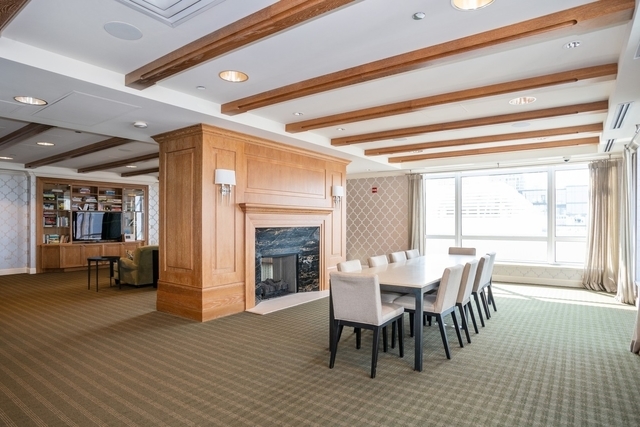 10 East Delaware Place, Unit 12E Chicago, IL 60611 - Photo 21 of 25 a dining room with furniture window and wooden floor