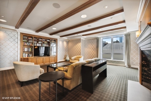 10 East Delaware Place, Unit 12E Chicago, IL 60611 - Photo 22 of 25 a living room with furniture and a flat screen tv