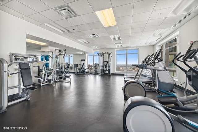10 East Delaware Place, Unit 12E Chicago, IL 60611 - Photo 23 of 25 a view of a room with gym equipment
