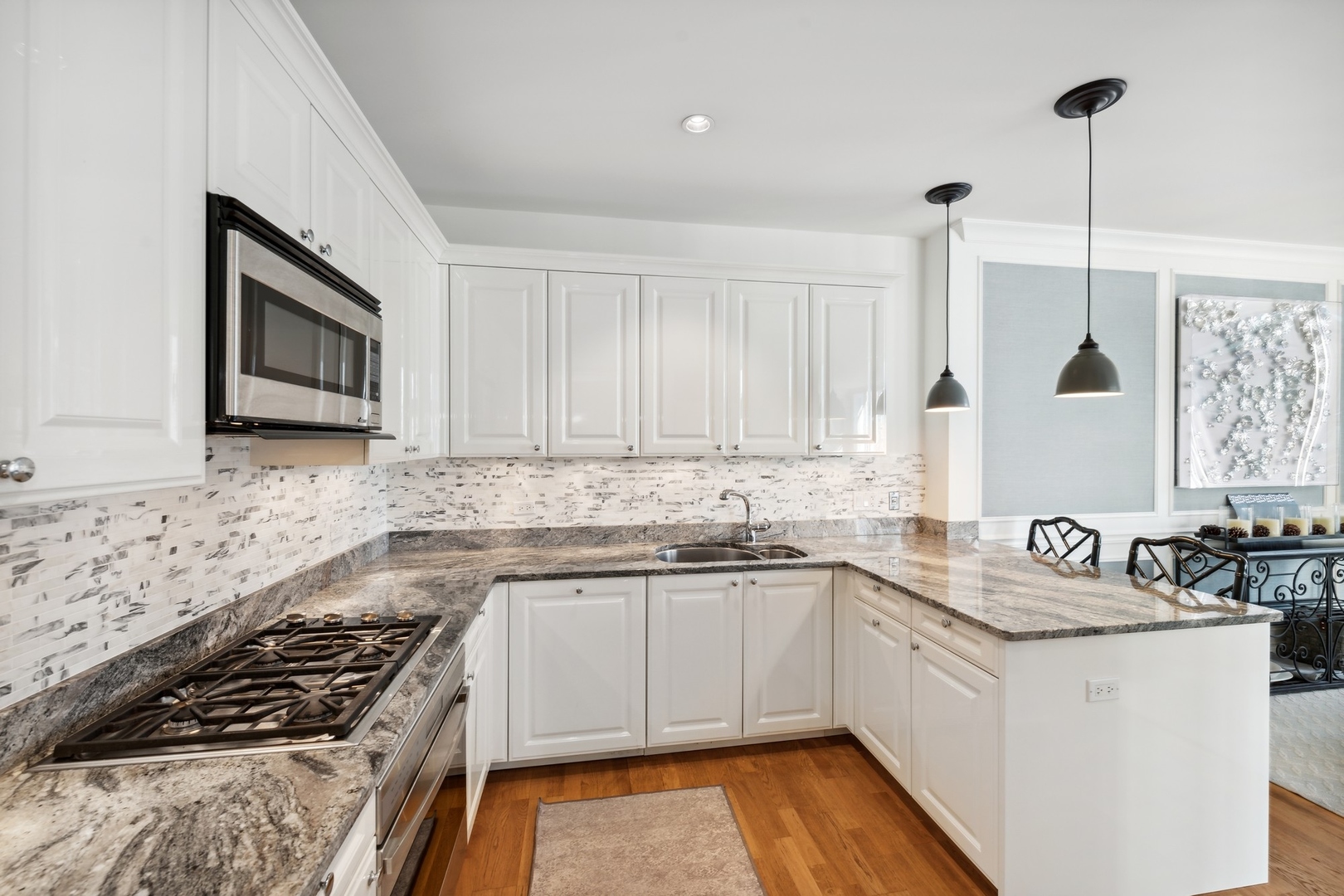 10 East Delaware Place, Unit 12E Chicago, IL 60611 - Photo 5 of 25 a kitchen with a sink stove and cabinets
