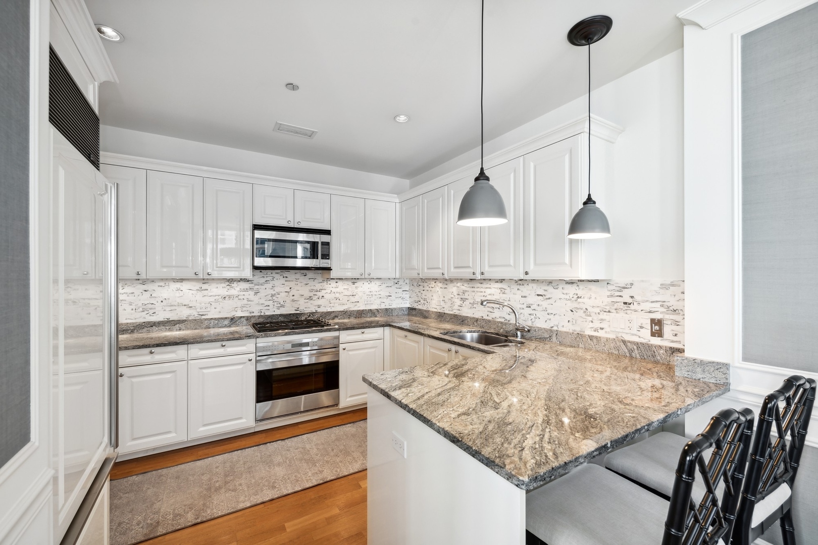10 East Delaware Place, Unit 12E Chicago, IL 60611 - Photo 6 of 25 a kitchen with a stove sink and microwave