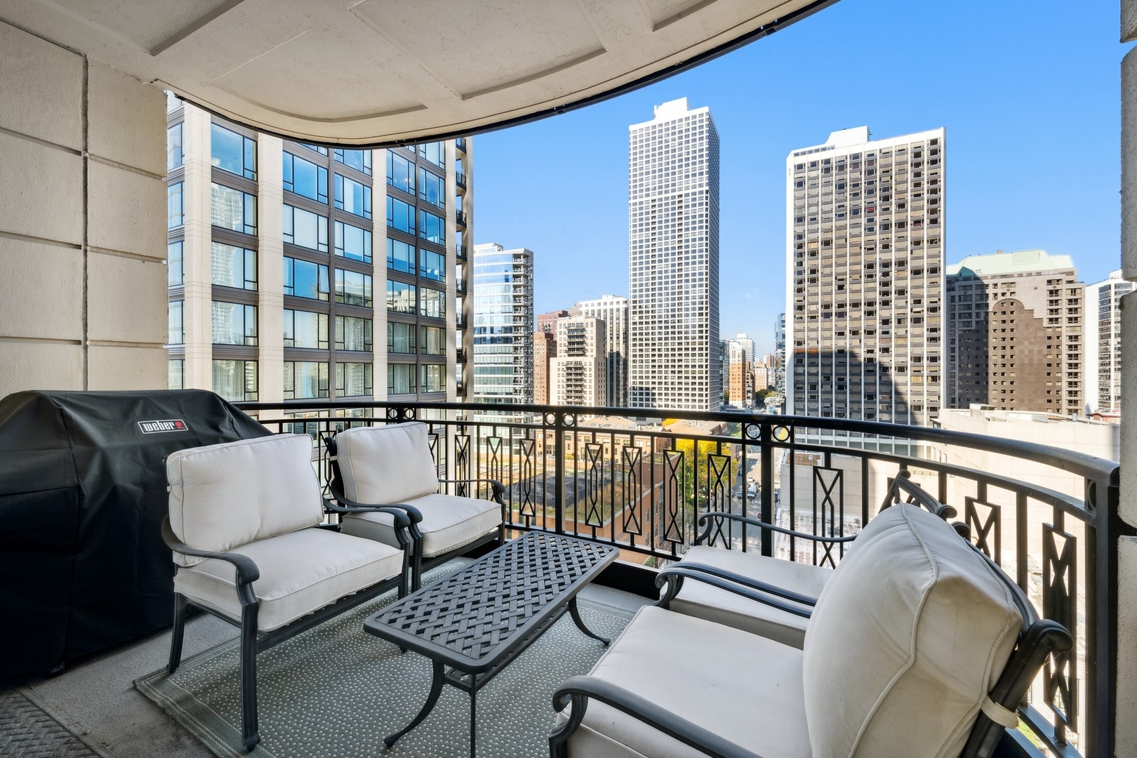 10 East Delaware Place, Unit 12E Chicago, IL 60611 - Photo 9 of 25 a balcony with couple of chairs and a couch