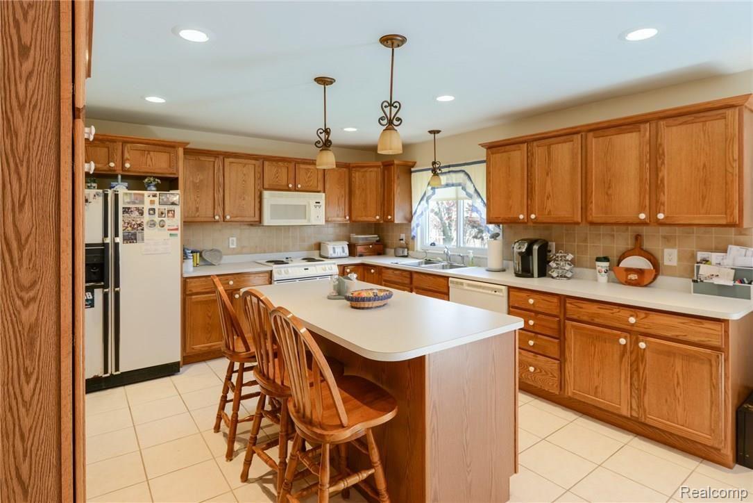 5821 West Hayner Road Fowlerville, MI 48836 - Photo 6 of 21 Lots of counter space and island can serve as a breakfast bar.