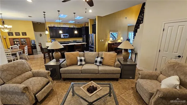 a living room with furniture and a chandelier
