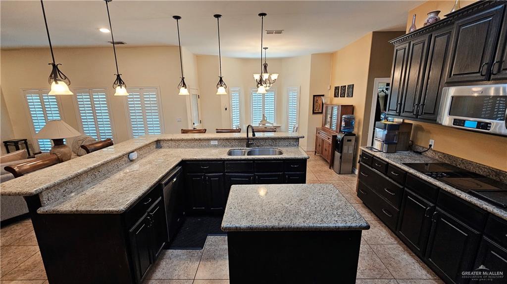 4711 North Stewart Road Palmhurst, TX 78573 - Photo 15 of 40 a kitchen with counter top space a sink and appliances